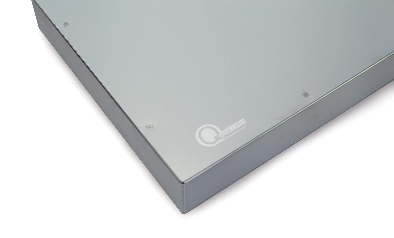Close-up of Qor Labs slide warmer edge showing engraved Qor Labs logo